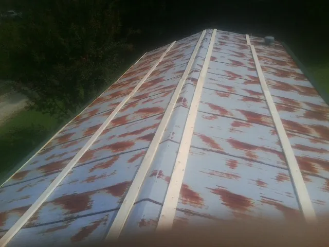 Rusted metal roof panels with new wood purlins before replacement — Storm Damage Roof Repair in Chester Gap by Roofing Brothers