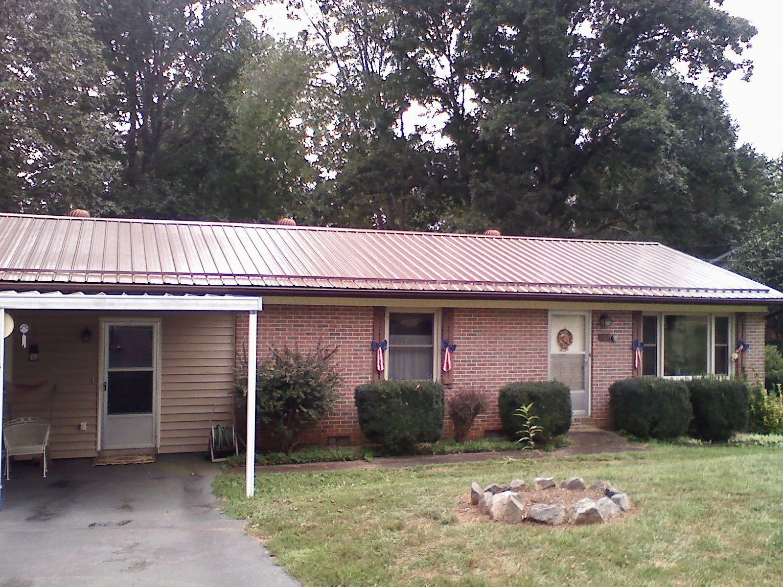 Bronze metal roof and carport on a brick ranch home — Roof Repair work by our crew in Chester Gap