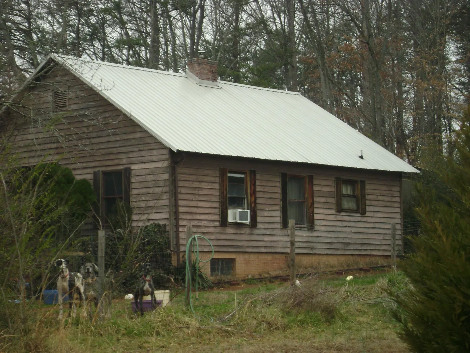 White metal roof on an old wood sided farmhouse, from a Metal Roof Installation job in Chester Gap